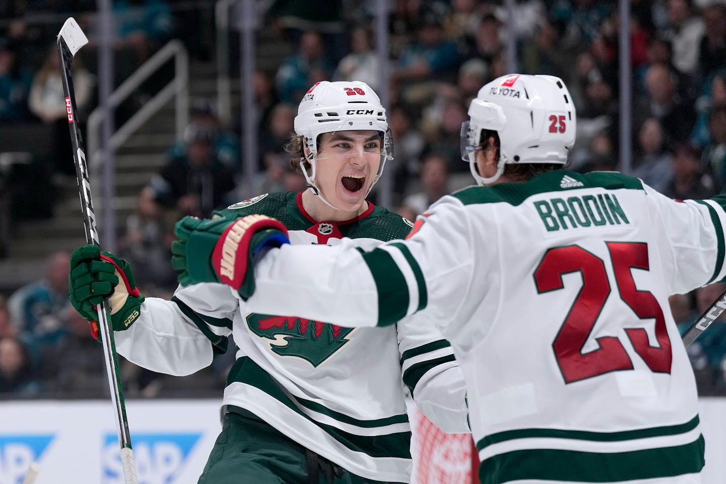 Wild winger Liam Ohgren celebrates with Jonas Brodin after scoring a goal against San Jose on Saturday.