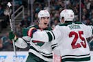 Wild winger Liam Ohgren celebrates with Jonas Brodin after scoring a goal against San Jose on Saturday.