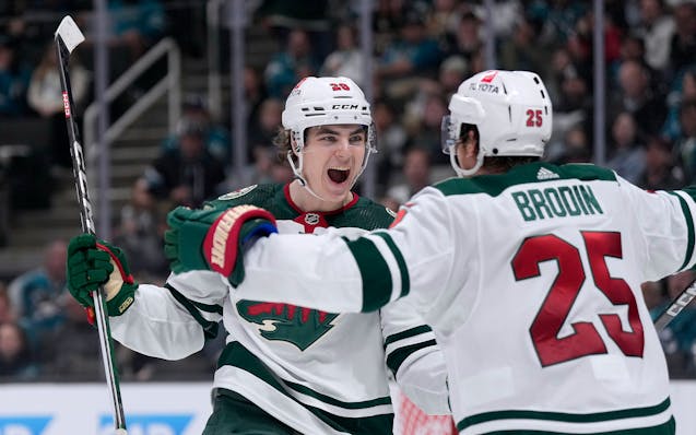Wild winger Liam Ohgren celebrates with Jonas Brodin after scoring a goal against San Jose on Saturday.