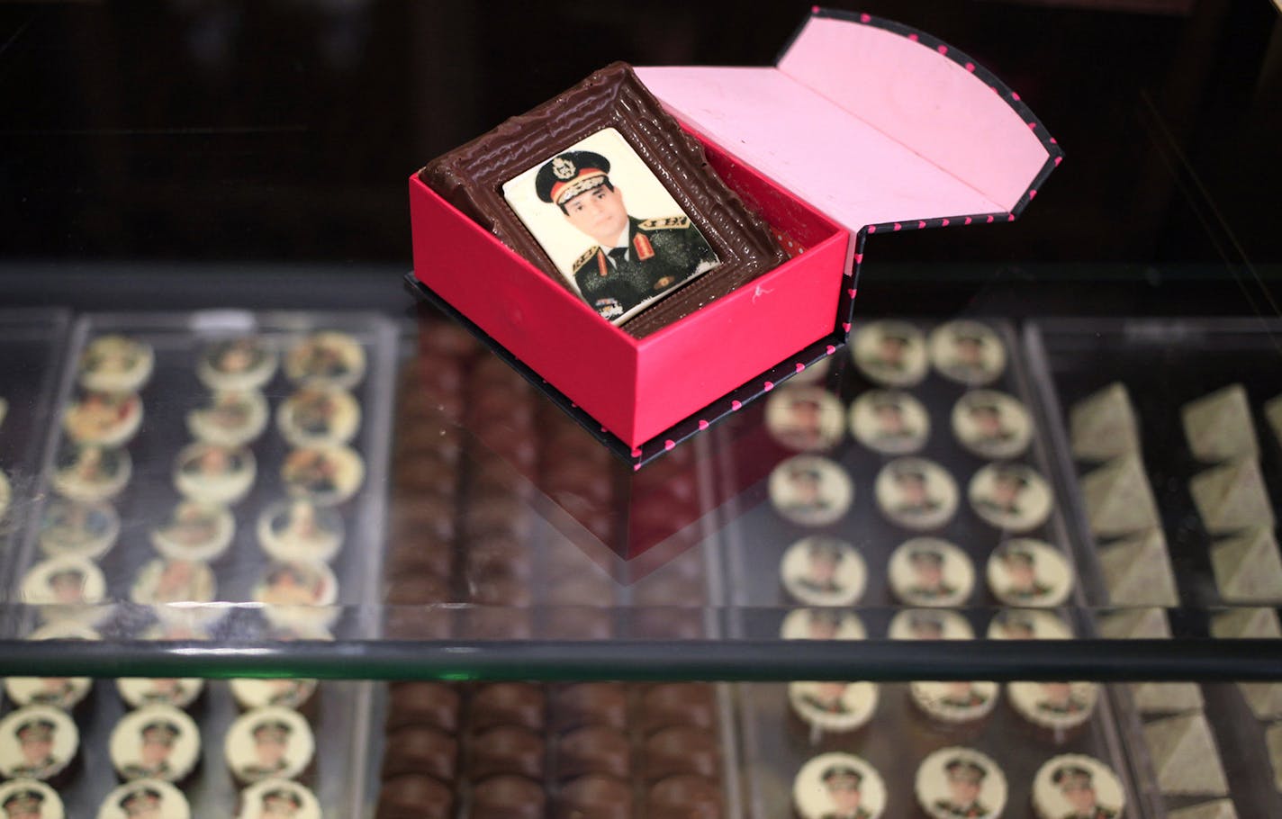 This Saturday, Sept. 14, 2013 photo shows chocolates decorated with pictures of Egyptian Defense Minister Gen. Abdel-Fattah el-Sissi displayed for sale in a shop in Cairo. A group of professionals and former army officers launch a petition urging Egypt&#x201a;&#xc4;&#xf4;s military chief to run for president, highlighting the yearning for a strongman to take charge after nearly three years of turmoil. The campaign is propped up by a pervasive personality cult based on the general's success in up