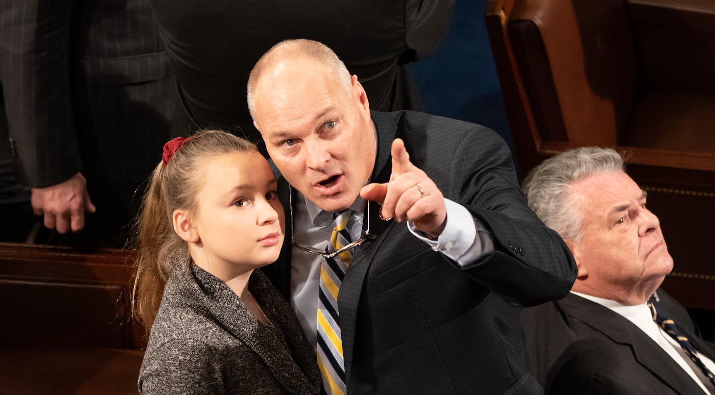 Rep. Pete Stauber pointed out to his daughter Addilynn, 12, their last name on the U.S. House voting board before he was sworn in as a new member of Congress.