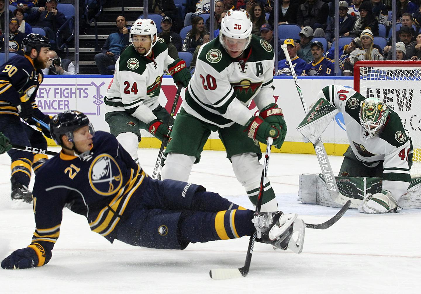 Buffalo Sabres Kyle Okposo (21) is brought down by Minnesota Wild's Ryan Suter (20) during the third period of an NHL hockey game, Thursday, Oct. 27, 2016, in Buffalo, N.Y. (AP Photo/Jeffrey T. Barnes)