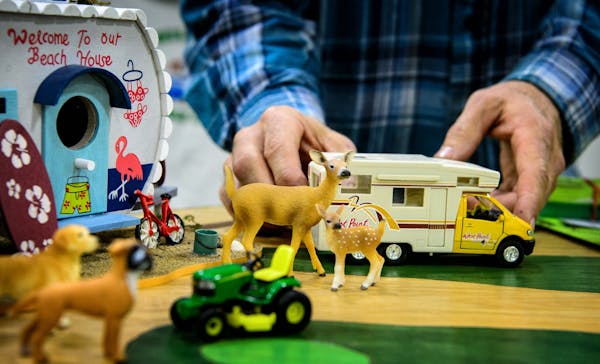 Todd Beyer, owner of the Wildwedge Golf, Mini-Golf and RV Park in Pequot Lakes, adjusted some of the camping toys in his display at the Minneapolis St
