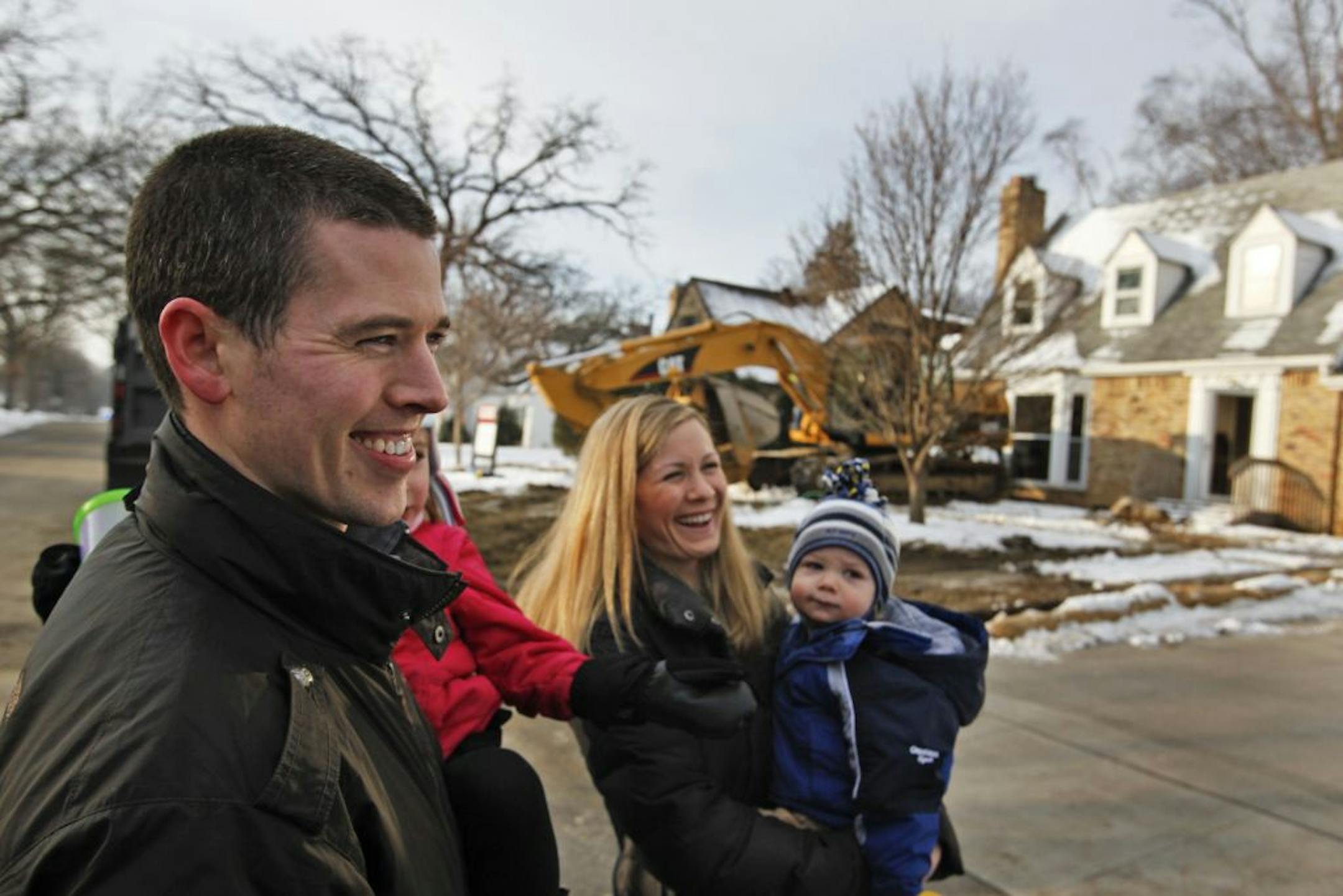 Tom and Kristen Ewers of Seattle and their two children were on hand last week to watch as the home they had bought in Edina was torn down.
