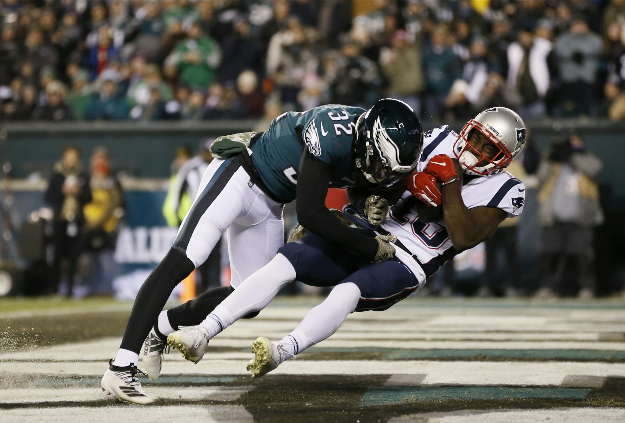 New England Patriots' Phillip Dorsett (13) hangs onto a touchdown pass against Philadelphia Eagles' Rasul Douglas (32) during the second half of an NFL football game against the Philadelphia Eagles, Sunday, Nov. 17, 2019, in Philadelphia. (AP Photo/Michael Perez)