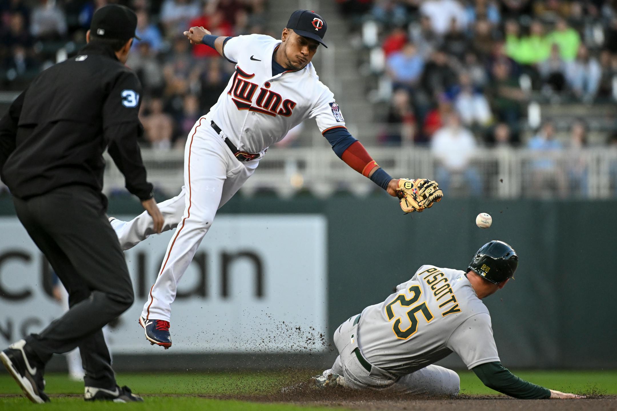 Oakland Athletics right fielder Stephen Piscotty (25) steals second as Minnesota Twins second baseman Jorge Polanco (11) is unable to make the play in the top of the second inning.