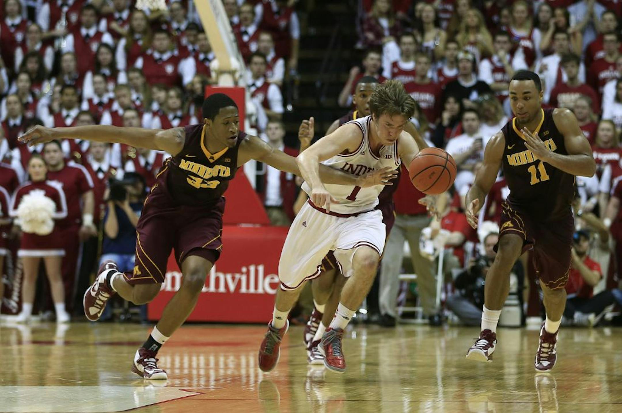 Indiana's Jordan Hulls (1) is fouled by Minnesota's Rodney Williams (33) during the second half of an NCAA college basketball game Saturday, Jan. 12, 2013, in Bloomington, Ind. Indiana defeated Minnesota 88-81.