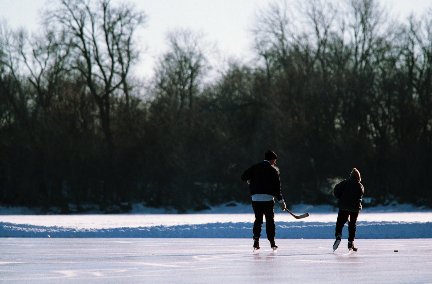 Wild Art........ Ice Skaters -- Jocko (cq) Reede, passes the puck to friend Kathy Kamby, both of Minneapolis while skating on the Lake of the Isles Wednesday afternoon. Reede decided to get some exercise and skate before going to work.