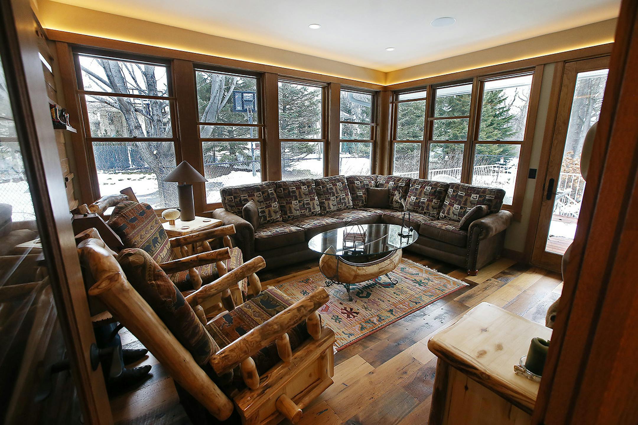 The room now has windows with built-in retractable screens so it can function as an airy porch in summer and a cozy retreat in winter.