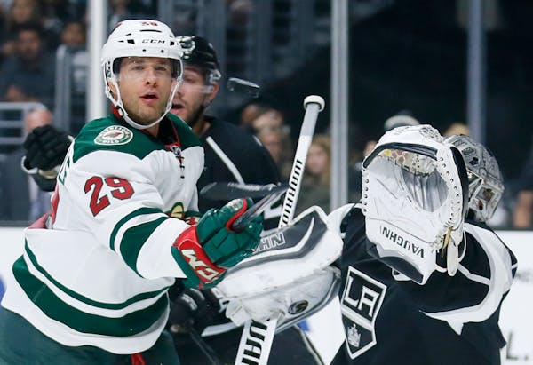 Minnesota Wild right wing Jason Pominville, left, eyes the puck as he tries to score past Los Angeles Kings goalie Jonathan Quick last season.