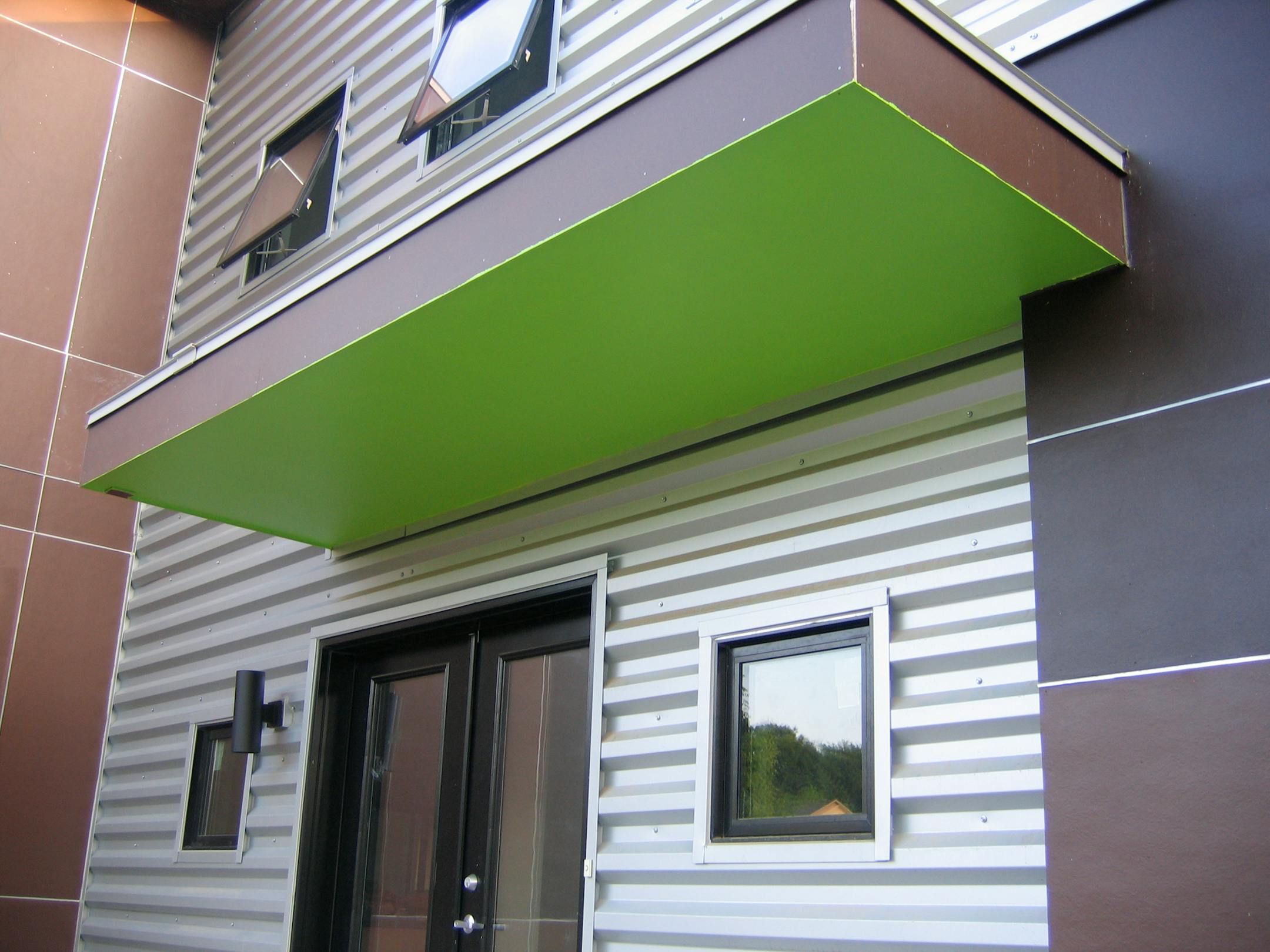 The Hardiboard around the garage got a two-tone color treatment of Turkish Coffee and Black Bean. Green on the overhang provided a nice contrast.
