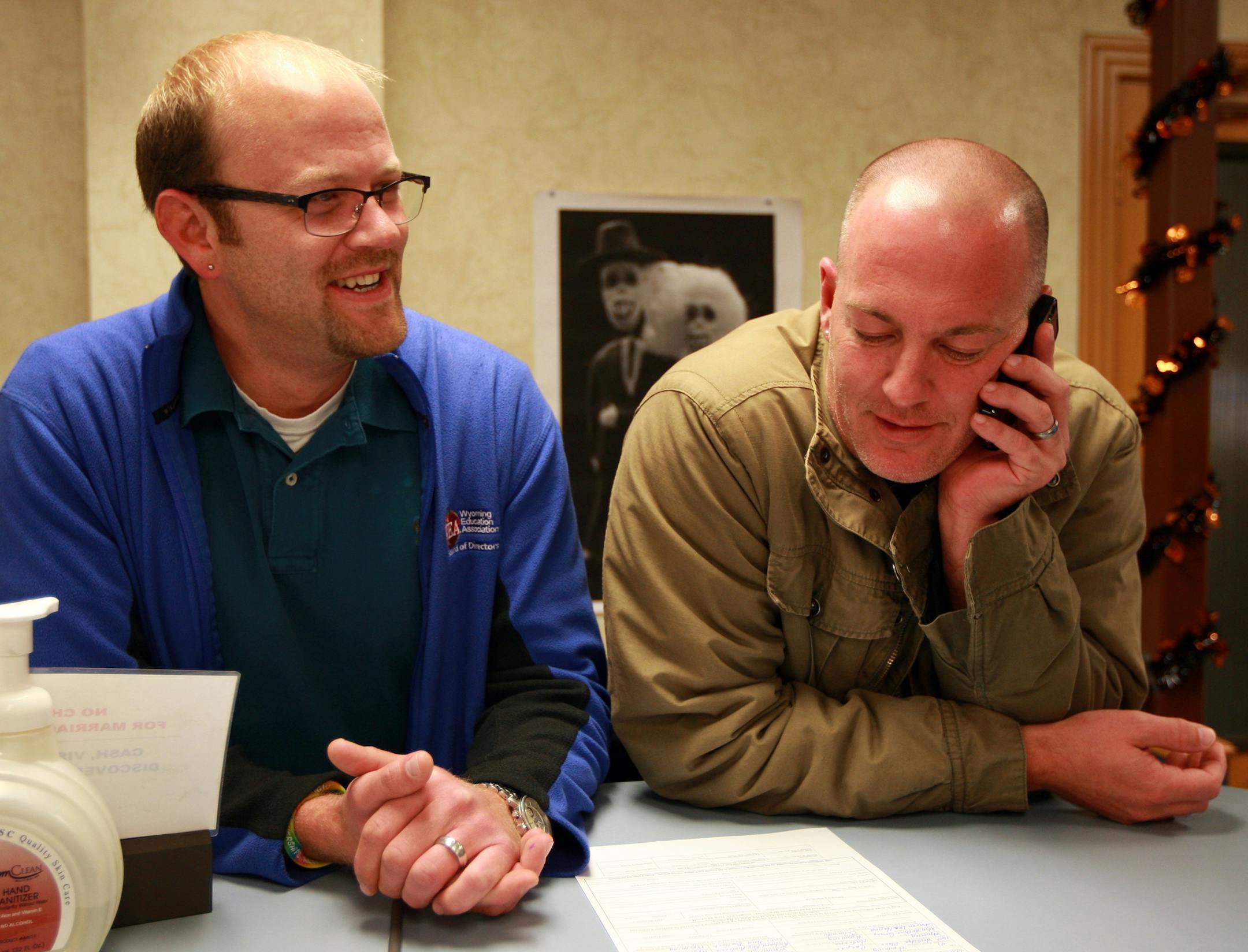 Dirk Andrews, left, and Travis Gray pick up their marriage license Tuesday morning, Oct. 21, 2014 at the Natrona County Clerk's office in Casper, Wyo. The two have been together for more than 10 years. Gay couples began to apply for marriage licenses Tuesday in Wyoming, shortly after the state began to recognize same-sex unions, albeit far more quietly than in other places where bans were recently struck down.(AP Photo/The Casper Star-Tribune, Alan Rogers)