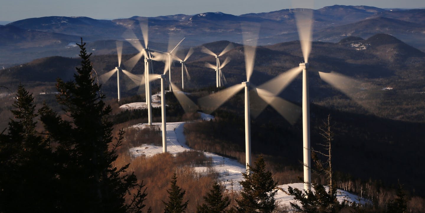 FILE - In this March 19, 2019 file photo, the blades of wind turbines catch the breeze at the Saddleback Ridge wind farm in Carthage, Maine. Scientists say emissions worldwide need to start falling sharply from next year if there is to be any hope of achieving the Paris climate accord&#x2019;s goal of capping global warming at 1.5 degrees Celsius (2.7 Fahrenheit). (AP Photo/Robert F. Bukaty, File)