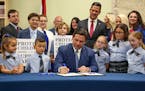 Florida Gov. Ron DeSantis signs the Parental Rights in Education bill, also known as the "Don't Say Gay" bill, on March 28, 2022, in Shady Hills, Fla.