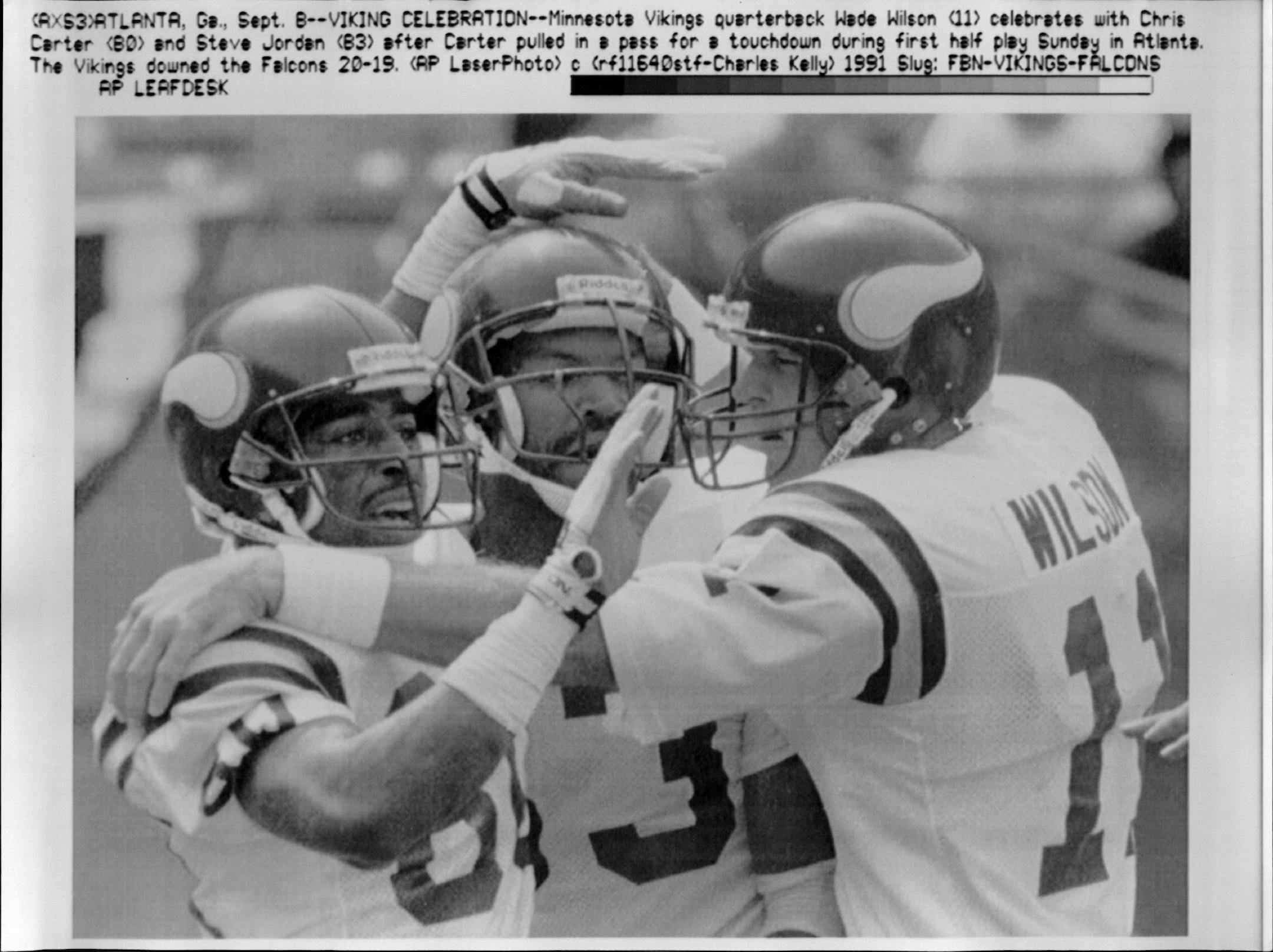September 8, 1991 Viking Celebration -- Minnesota Vikings quarterback Wade Wilson (11) celebrates with Chris Carter (80) and Steve Jordan (83) after Carter pulled in a pass for a touchdown during first half play Sunday in Atlanta. The Vikings downed the Falcons 20-19. September 9, 1991 Charles Kelly, AP Laserphoto
