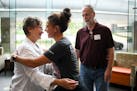 Critical care nurse Holly Vilione, right, embraces Deb and Rick Ulrich, of Norwood Young America, as they part ways Thursday, May 11, 2023, in the atr