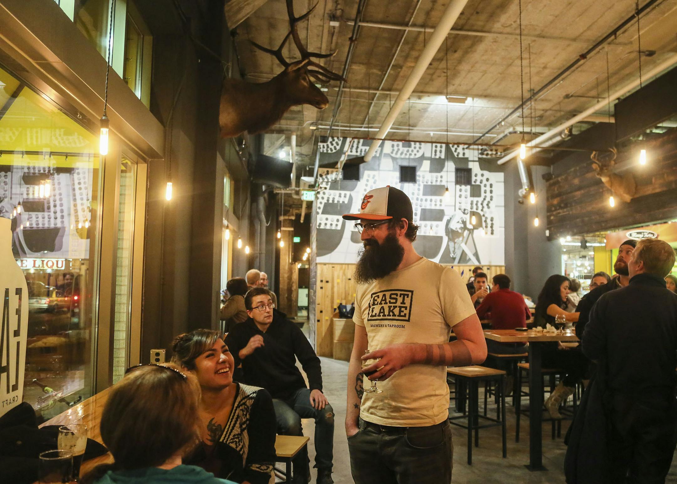 Eastlake Craft Brewery owner Ryan Pitman mingles with customers while enjoying a Nicollet Mauler (black IPA) in the Midtown Global Market Friday, Dec. 12, 2014, in Minneapolis, MN. ](DAVID JOLES/STARTRIBUNE)djoles@startribune.com Eastlake Craft Brewery in the Midtown Global Market is the newest brewery and boasts craftsman-brewed ales and lagers and has a prominent location.
