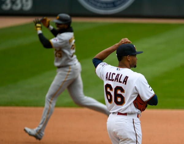 Minnesota Twins pitcher Jorge Alcala watches Pittsburgh Pirates Gregory Polanco round the bases after Polanco hit a home run during the eighth inning 