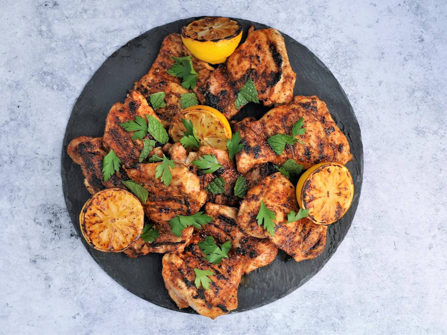 Grilled Spice-Rubbed Chicken Thighs with Lemon and Herbs. Recipe and photo by Meredith Deeds, Special to the Star Tribune