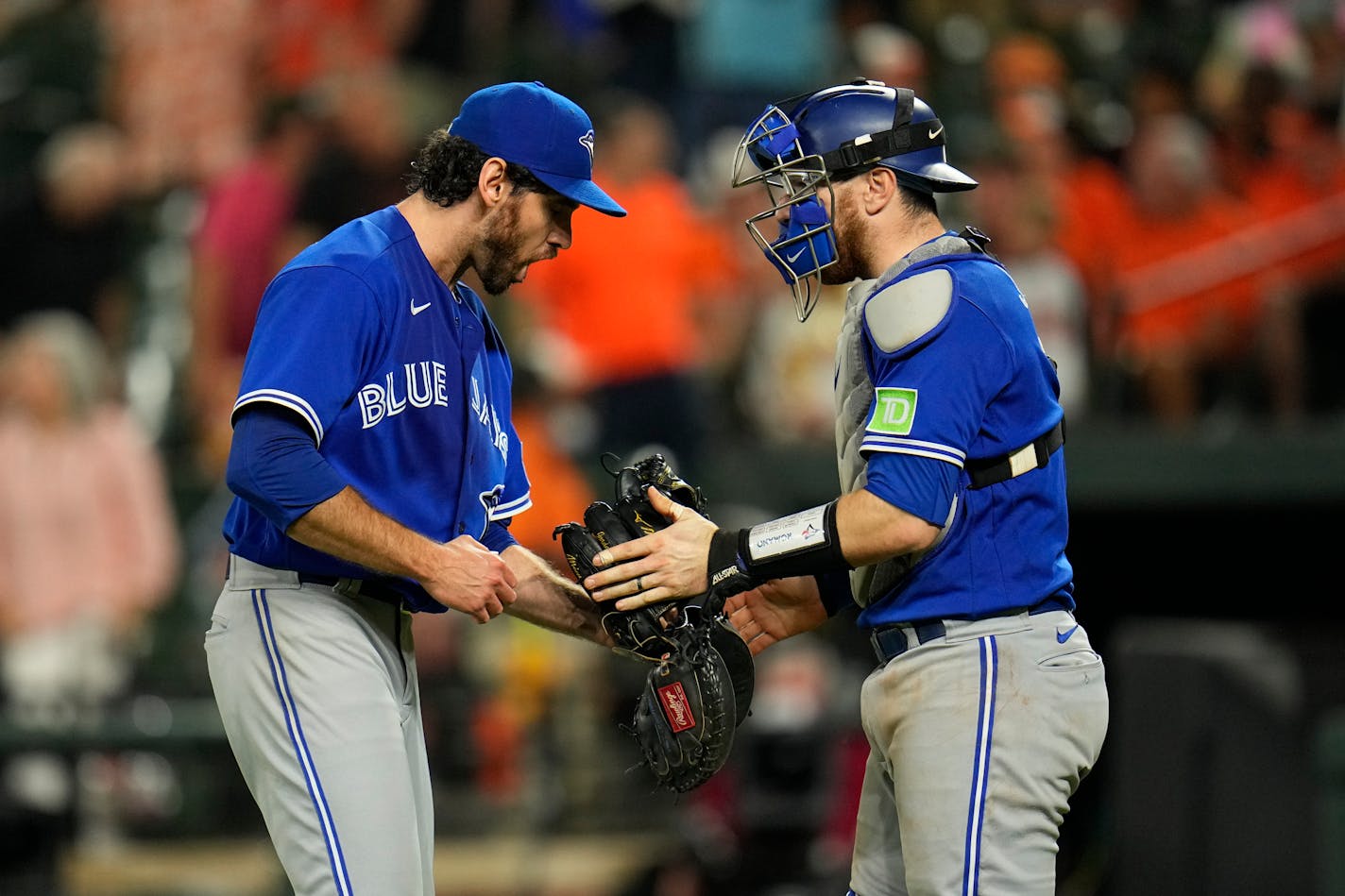 Toronto Blue Jays relief pitcher Jordan Romano, left, and catcher Danny Jansen react after a baseball game against the Baltimore Orioles, Tuesday, Aug. 22, 2023, in Baltimore. The Blue Jays won 6-3. (AP Photo/Julio Cortez)