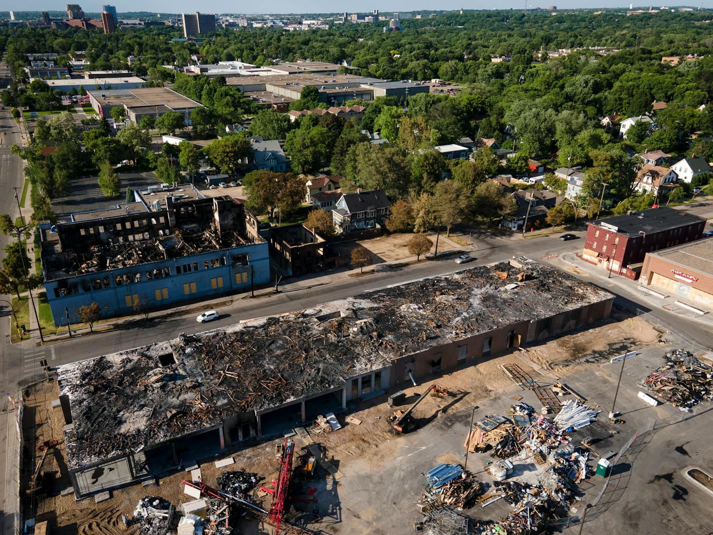 The Midtown Corners housing project after it was burned down and again a year later, now renamed Everlake.