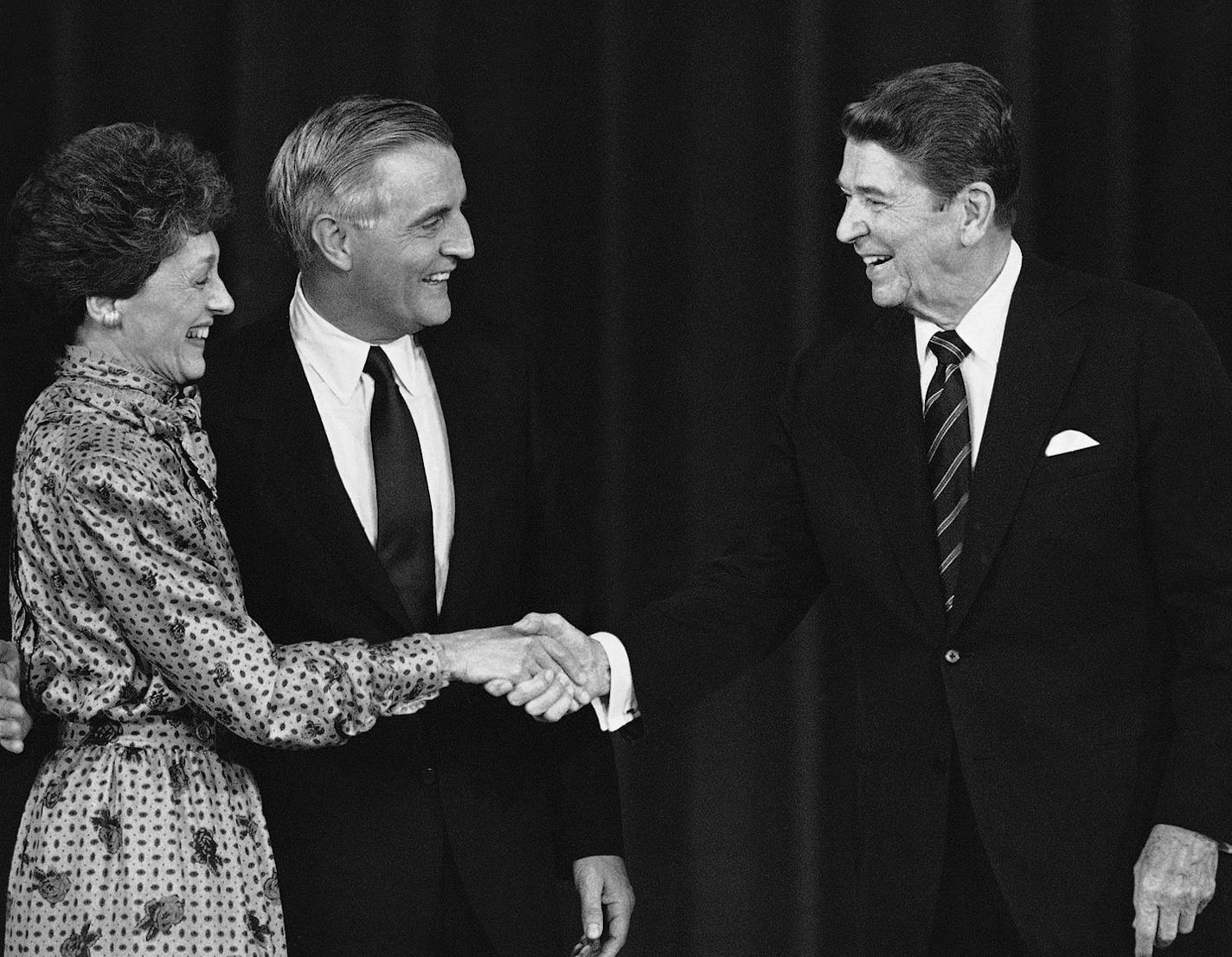 President Ronald Reagan shakes hands with Joan Mondale as Democratic presidential candidate Walter Mondale brings them together on the stage after debate at night on Sunday, Oct. 7, 1984 in Louisville. (AP Photo/Ron Edmonds)