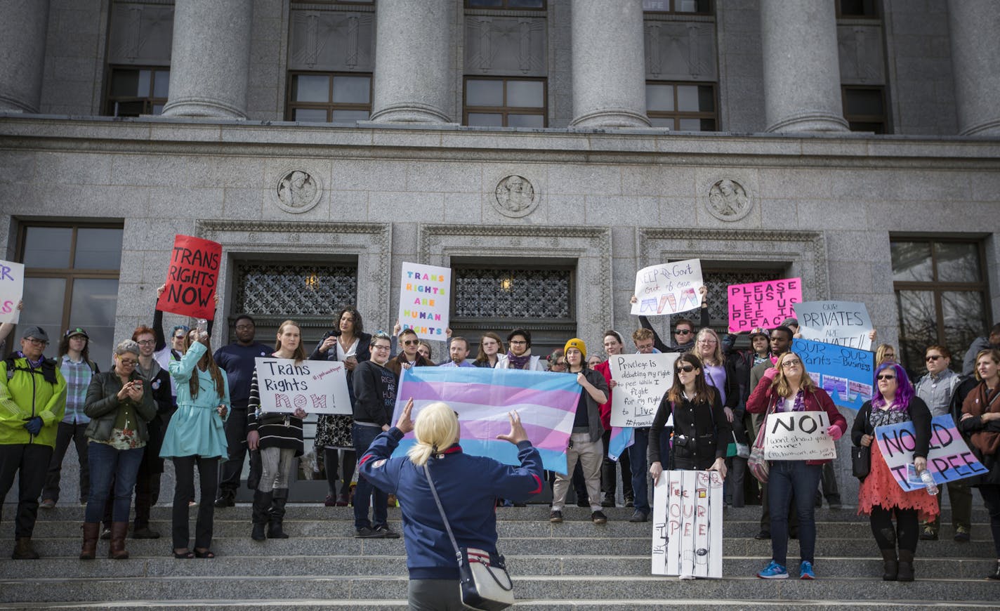 People listen to speakers during a Transgender Day of Visibility rally at the Capitol in St. Paul. ] (Leila Navidi/Star Tribune) leila.navidi@startribune.com BACKGROUND INFORMATION: Thursday, March 31, 2016. About 50 transgender people and their allies rallied at the State Office Building at the Capitol in St. Paul during Transgender Day of Visibility to protest a GOP bill seeking to mandate the use of public restrooms in accordance with one&#x2019;s original birth certificate.