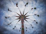 State Fair goers spun nearly 100 feet in the air on the Sky Flyer at the Mighty Midway.