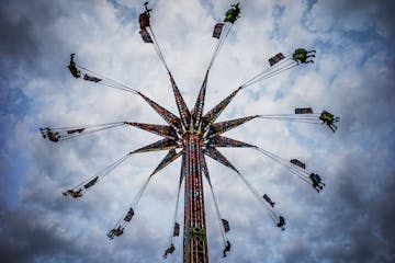 State Fair goers spun nearly 100 feet in the air on the Sky Flyer at the Mighty Midway.