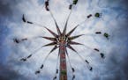 State Fair goers spun nearly 100 feet in the air on the Sky Flyer at the Mighty Midway.