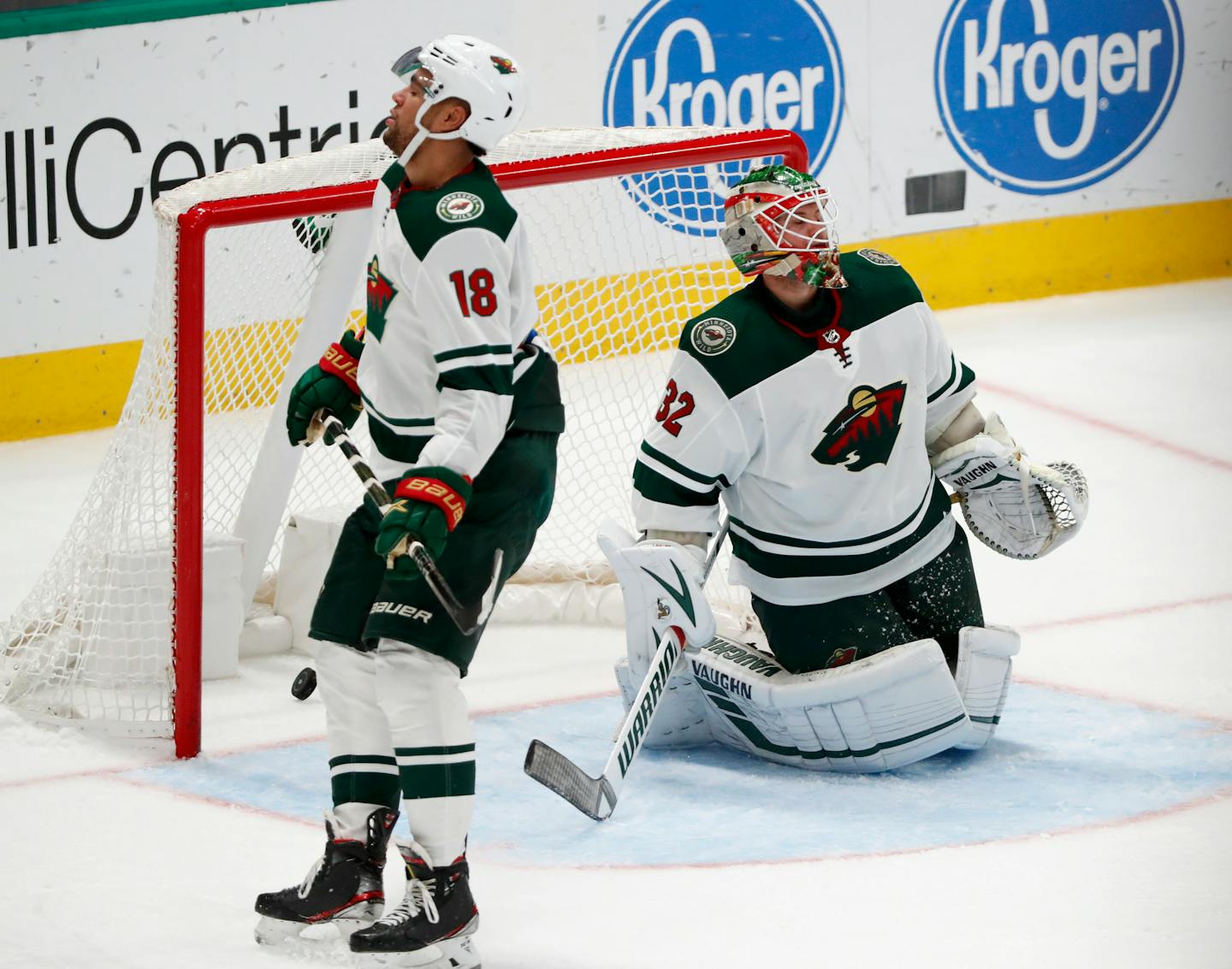 The Wild's Jordan Greenway and Alex Stalock look away after the Stars' Joe Pavelski scored in the third period