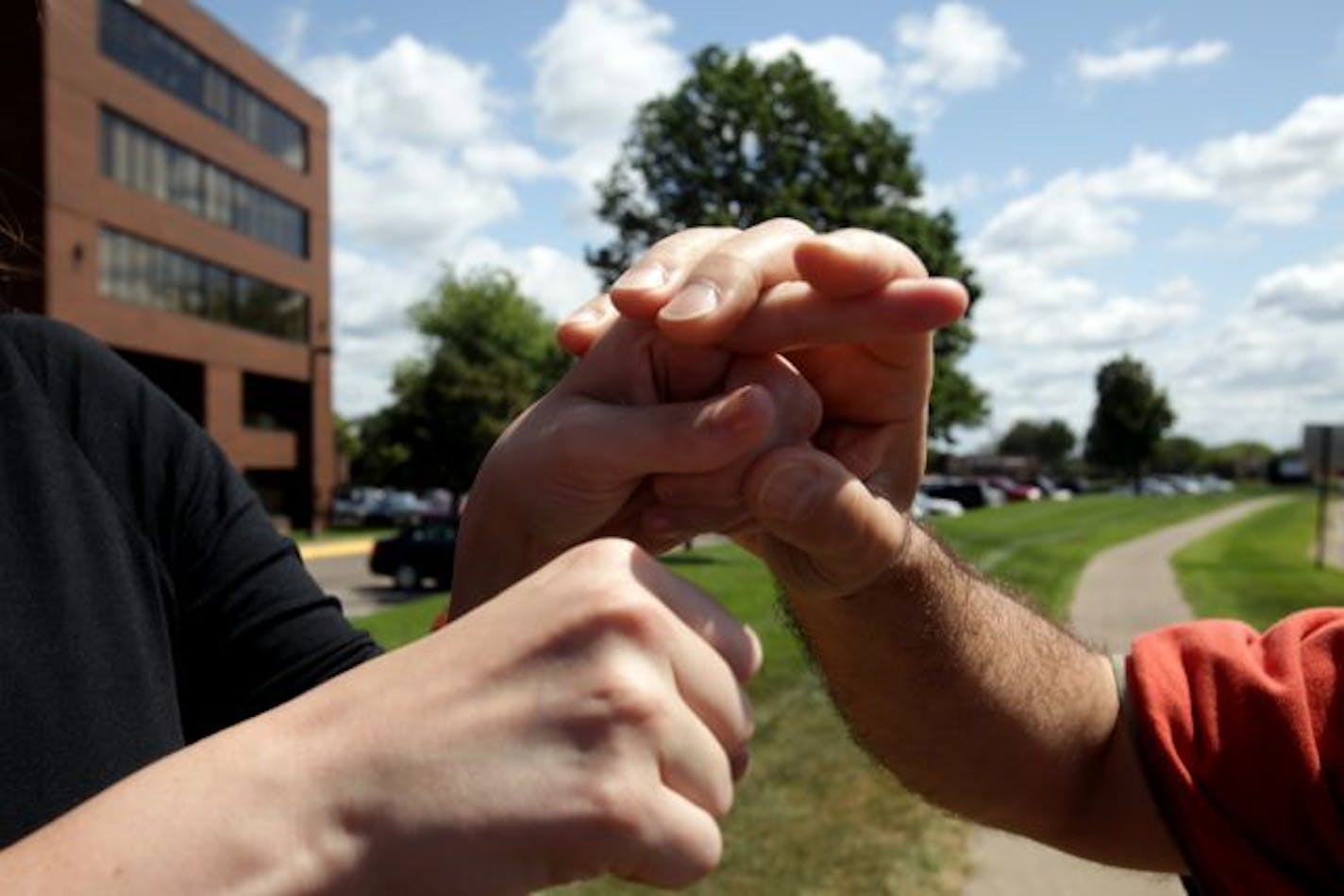 Deaf blind interpreter Claire Alexander communicated with Jose Herrera by signing in his hand as they talked about heading to the bus stop that he uses.