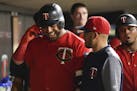 Minnesota Twins designated hitter Nelson Cruz (23) celebrated with teammates after hitting his third home run of the night against the Kansas City Roy