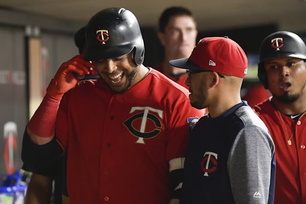 Minnesota Twins designated hitter Nelson Cruz (23) celebrated with teammates after hitting his third home run of the night against the Kansas City Roy