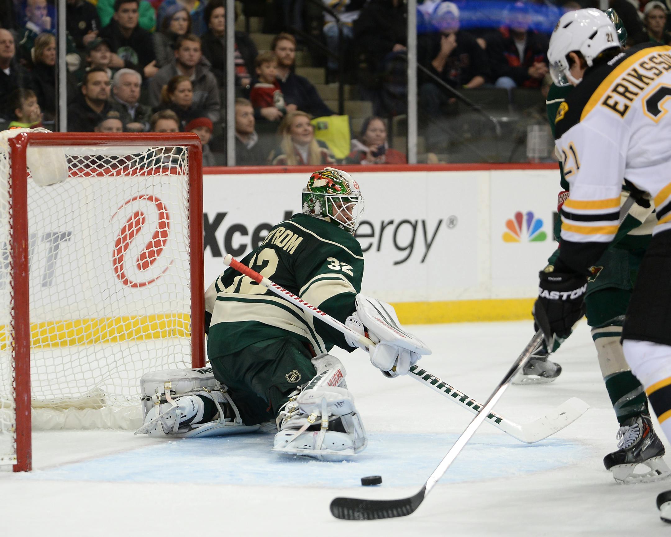 Boston Bruins left wing Loui Eriksson (21) serves up a game-winning goal from behind the back of Minnesota Wild goalie Niklas Backstrom (32) in overtime Wednesday night.