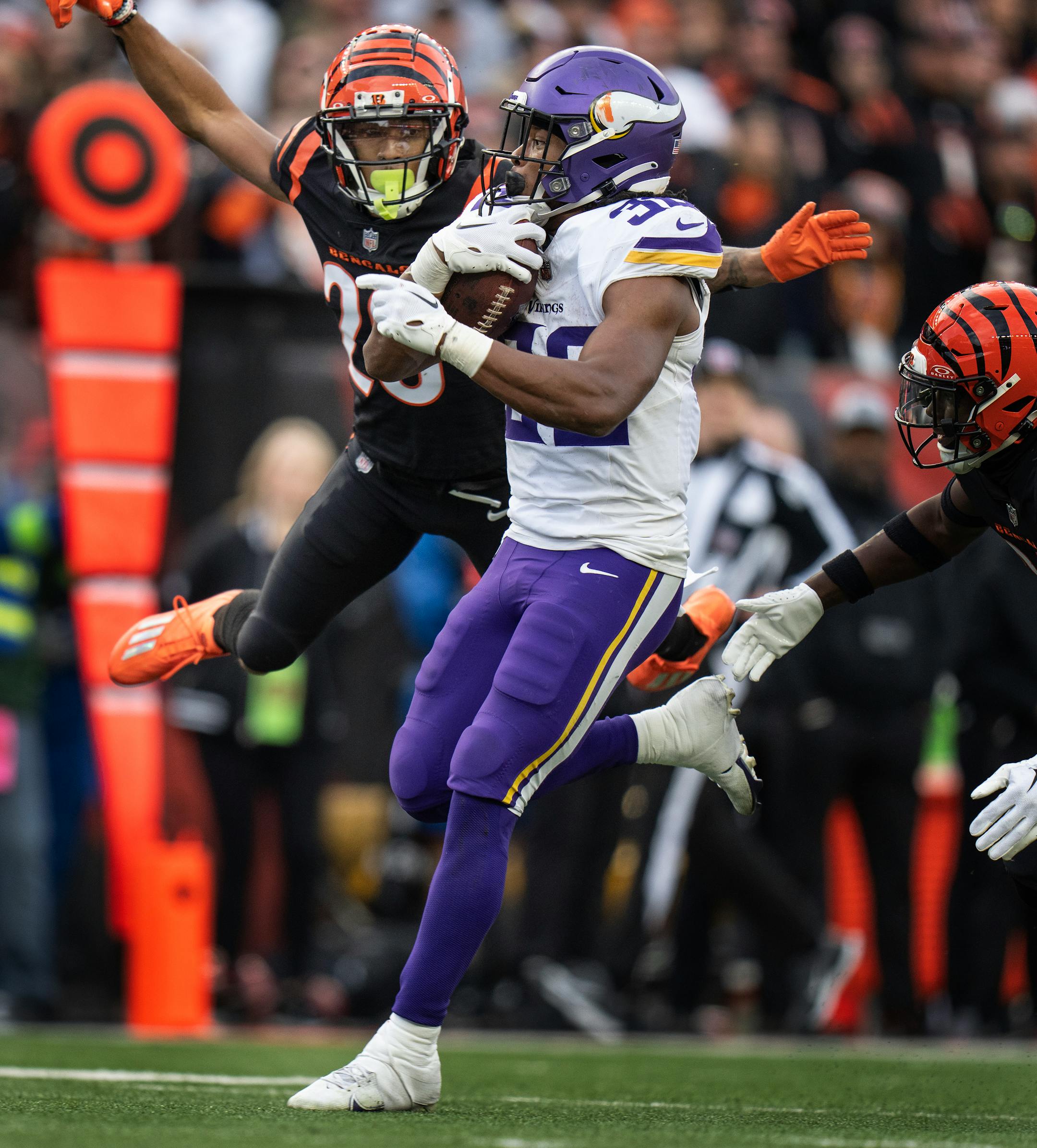 Cincinnati Bengals cornerback DJ Turner II (20) jumped for Minnesota Vikings running back Ty Chandler (32) as he picked up a first down, before he was tackled at the one yard line Saturday December ,16 ,2023 in,Cincinnati, OH. ] JERRY HOLT • jerry.holt@startribune.com