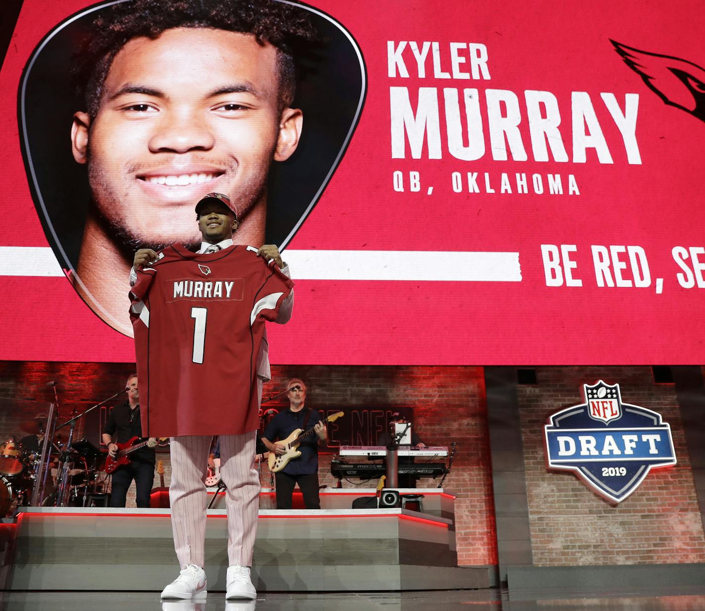 Oklahoma quarterback Kyler Murray shows off his new jersey after the Arizona Cardinals selected Murray in the first round at the NFL football draft, Thursday, April 25, 2019, in Nashville, Tenn. (AP Photo/Mark Humphrey)