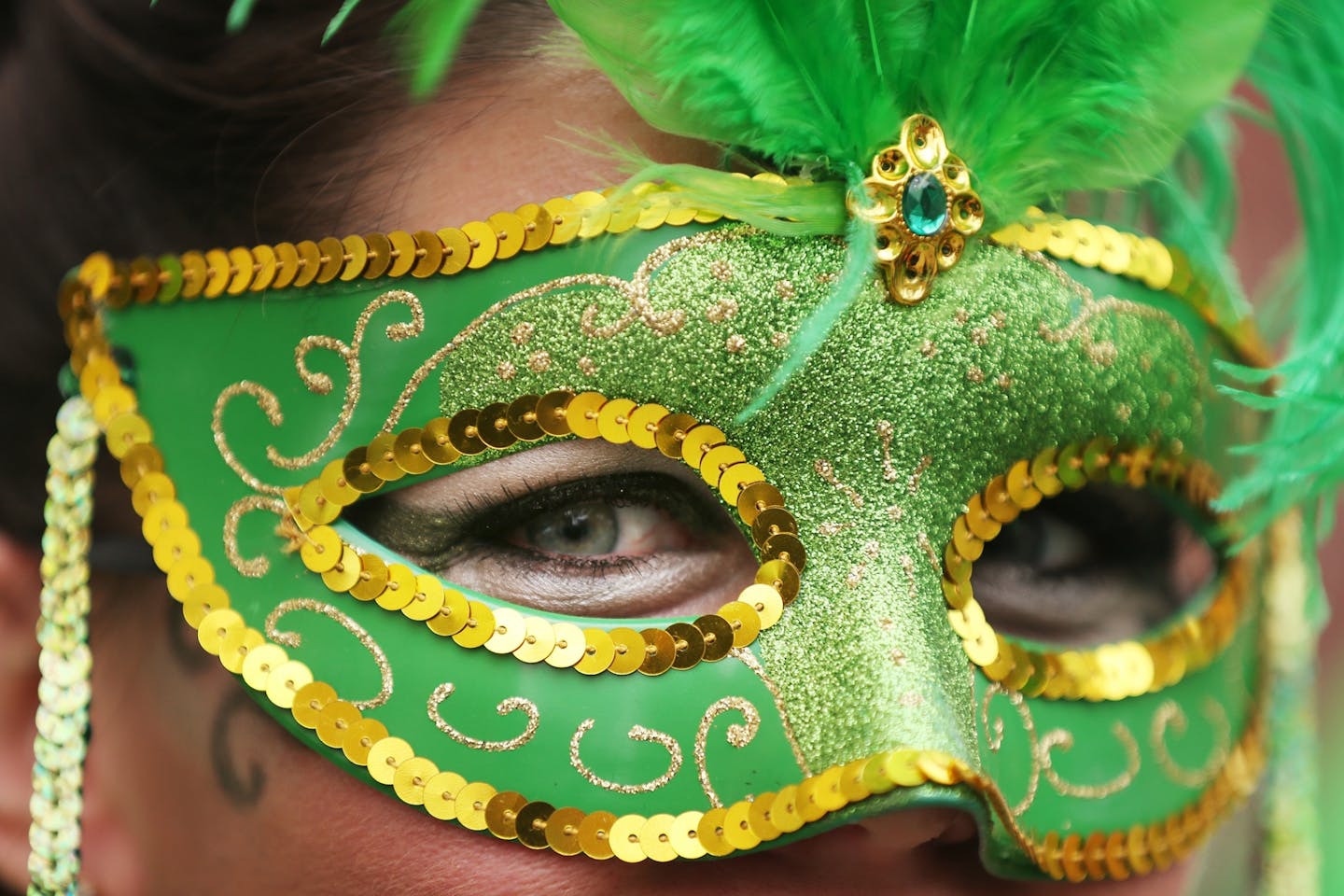 Colleen Vickers of Crystal sports a festive mask during the St. Patrick's Parade in downtown St. Paul.