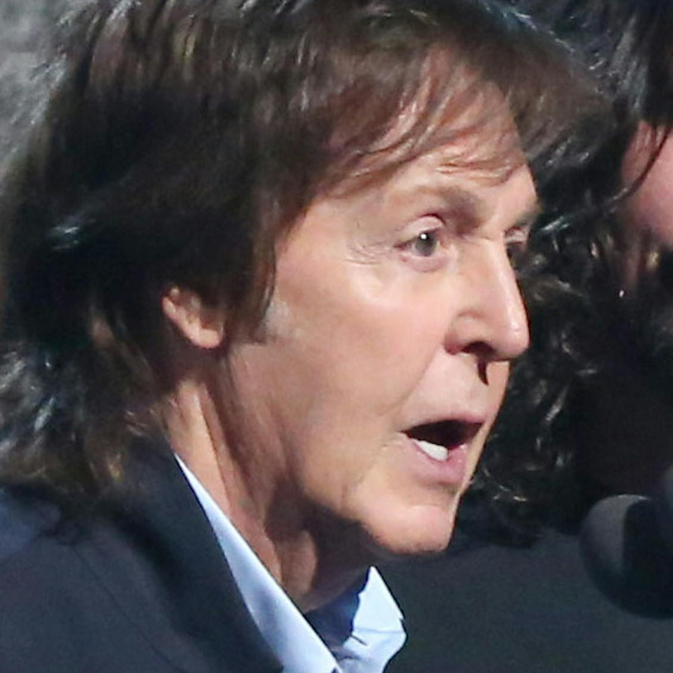 Krist Novoselic, left, looks on as Paul McCartney, center left, and Dave Grohl, center right, accept the award for best rock song for ìCut Me Some Slack at the 56th annual Grammy Awards at Staples Center on Sunday, Jan. 26, 2014, in Los Angeles. (Photo by Matt Sayles/Invision/AP)