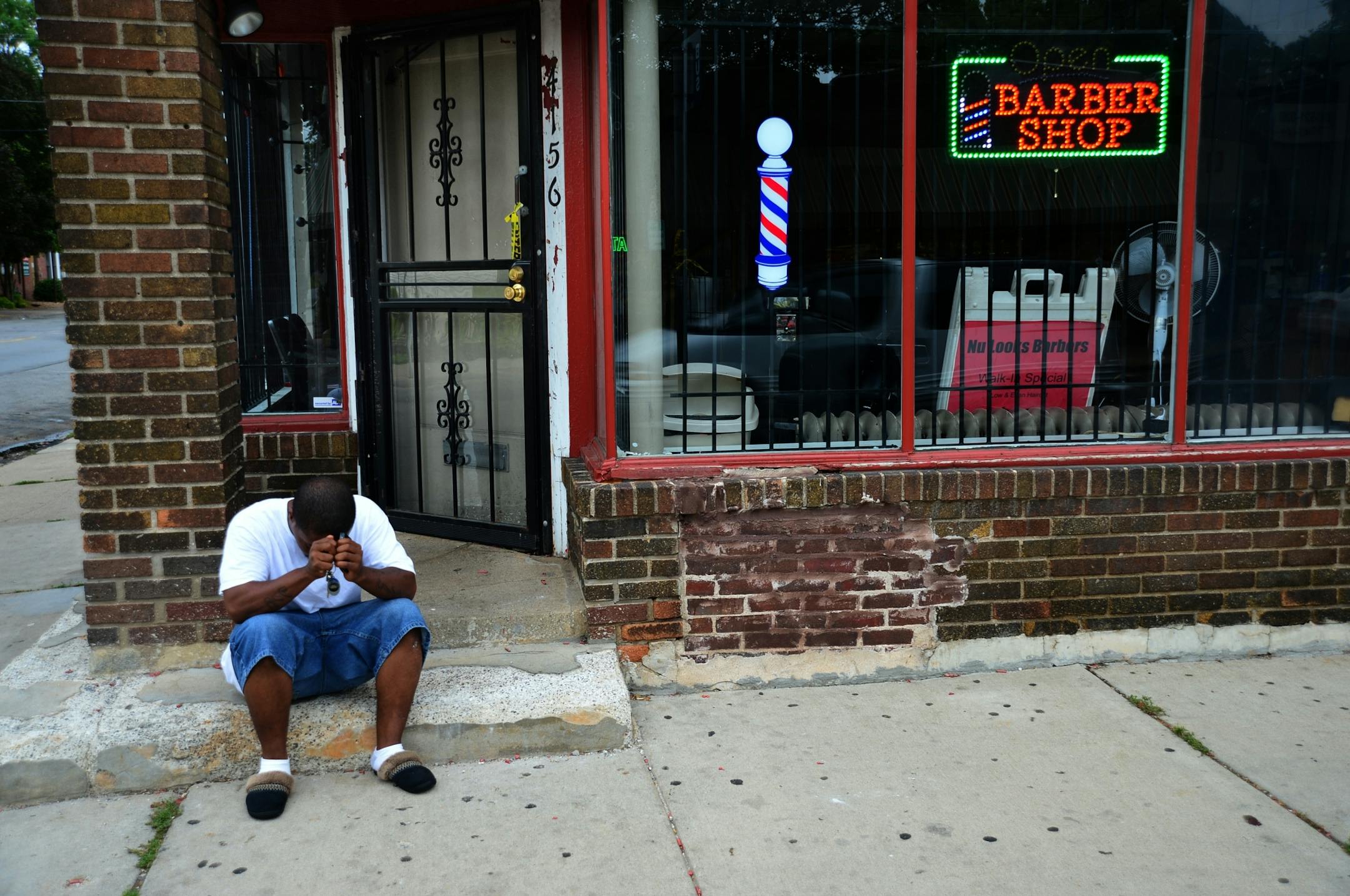 A man was fatally shot Thursday night and found in a vehicle at 42nd and Fremont Avenues North in Minneapolis, police said. Johnnell Lane of minneapolis sit's with his head in his hands near where his friend was shot to death last night.