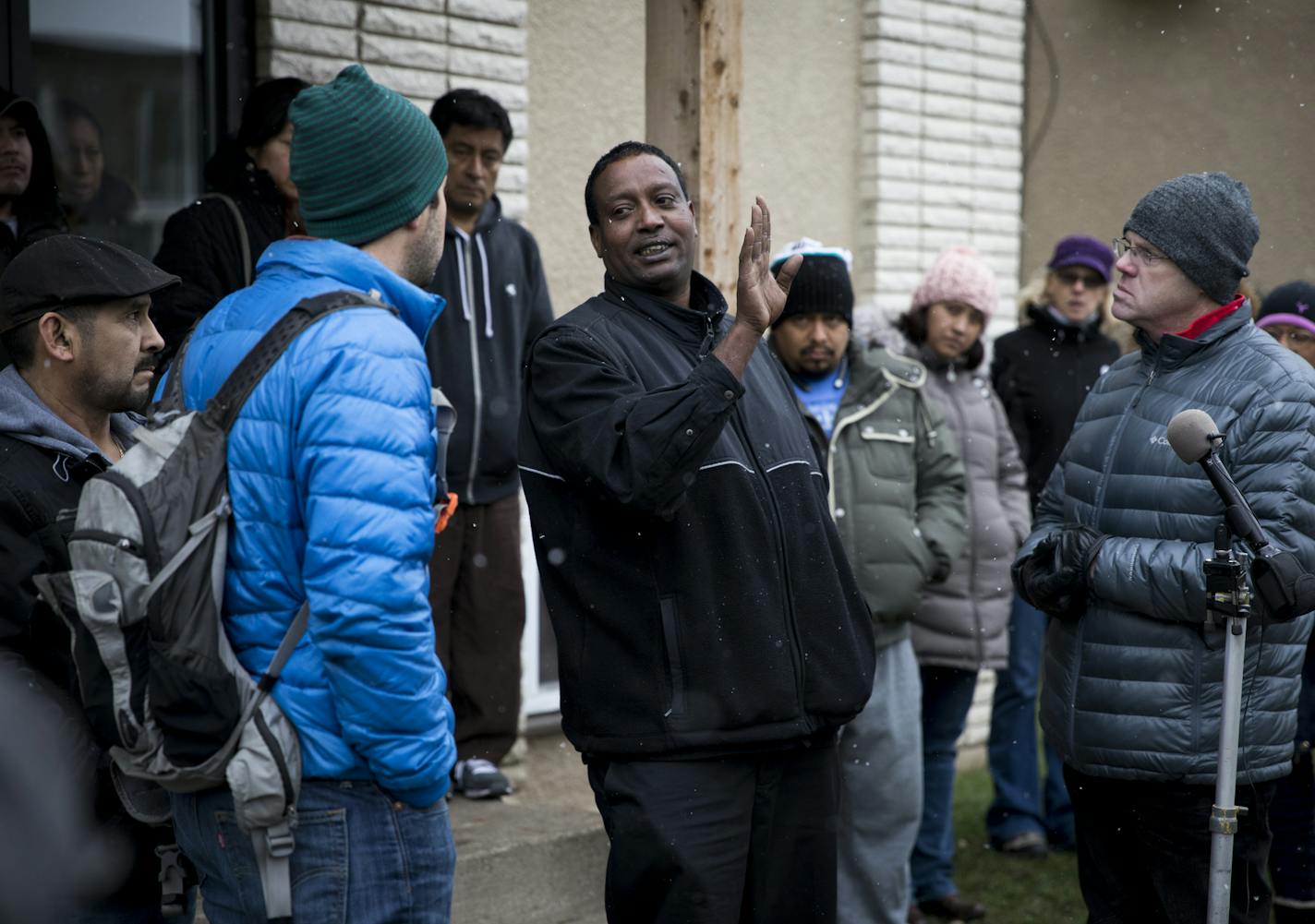 Renter Abdi Dhimbil talked Roberto De la Riva, with Renters United for Justice, left, and with QT property managment general manager Matthew Mock, right, who showed up to give his side of the story to the protesting of rising rents at a series of buildings along Pleasant and Pillsbury Avenue on Tuesday, November 22, 2016, in Minneapolis, Minn. ] RENEE JONES SCHNEIDER &#x2022; renee.jones@startribune.com