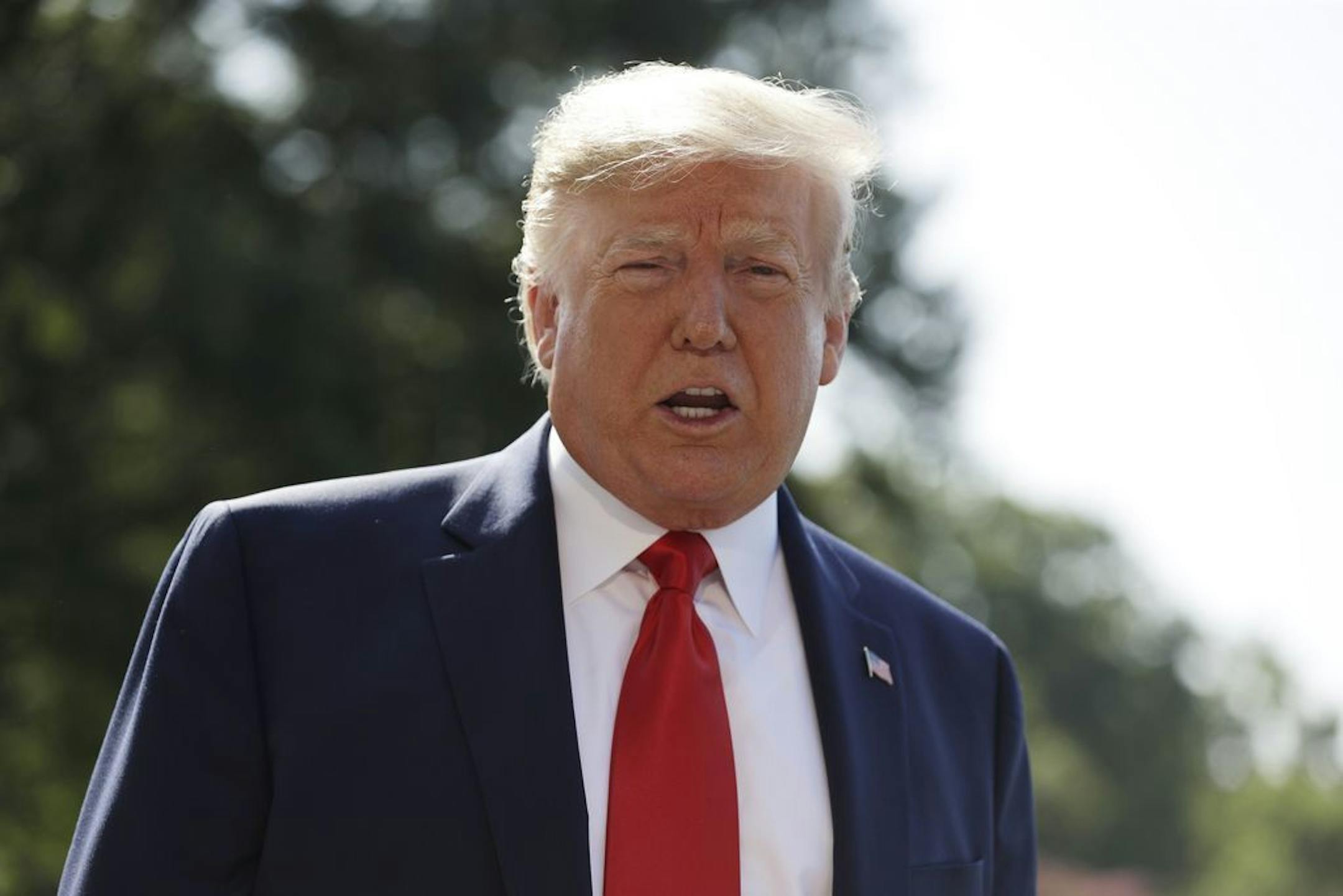 President Donald Trump talks to reporters on the South Lawn of the White House, Friday, Aug. 9, 2019, in Washington.