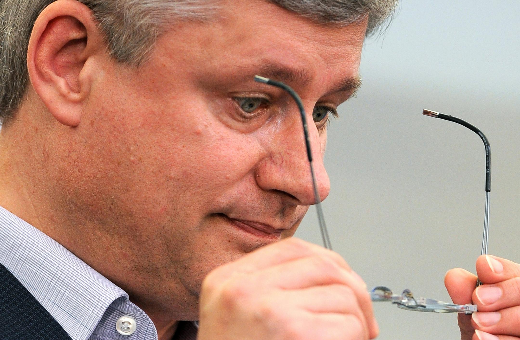 Canada's Prime Minister Stephen Harper removes his glasses while answering questions during a media conference during the G-8 summit at the Lough Erne golf resort in Enniskillen, Northern Ireland, on Tuesday, June 18, 2013. The final day of the G-8 summit of wealthy nations is ending with discussions on globe-trotting corporate tax dodgers, a lunch with leaders from Africa, and suspense over whether Russia and Western leaders can avoid diplomatic fireworks over their deadlock on Syriaís civ