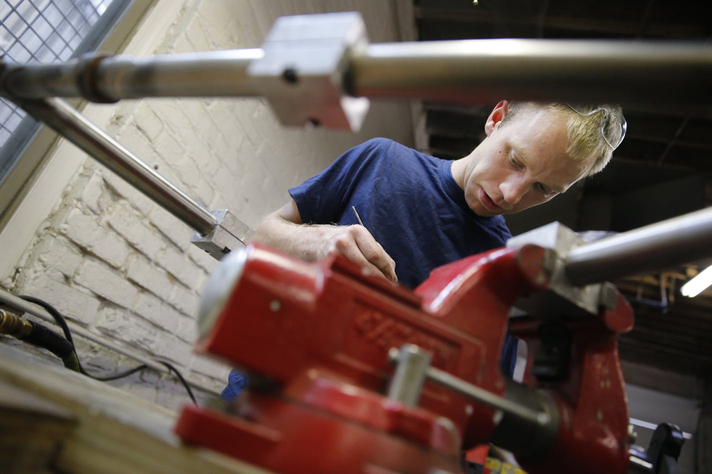 At his workshop in south Minneapolis, 25-year-old Alex Cook bike frame builder worked on a custom made stainless steel frames, his specialty. ] tsong-taataarii@startribune.com