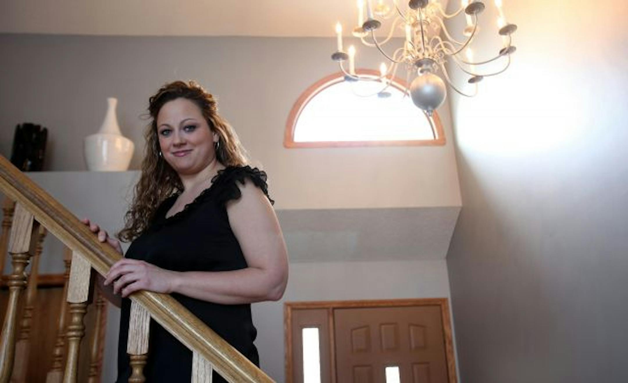 Lindsey Rafnson 26, is on the stairs her newly decorated living room in Eagan. Rafnson took part on the First Time Homebuyer Program offered by the Dakota County CDA.