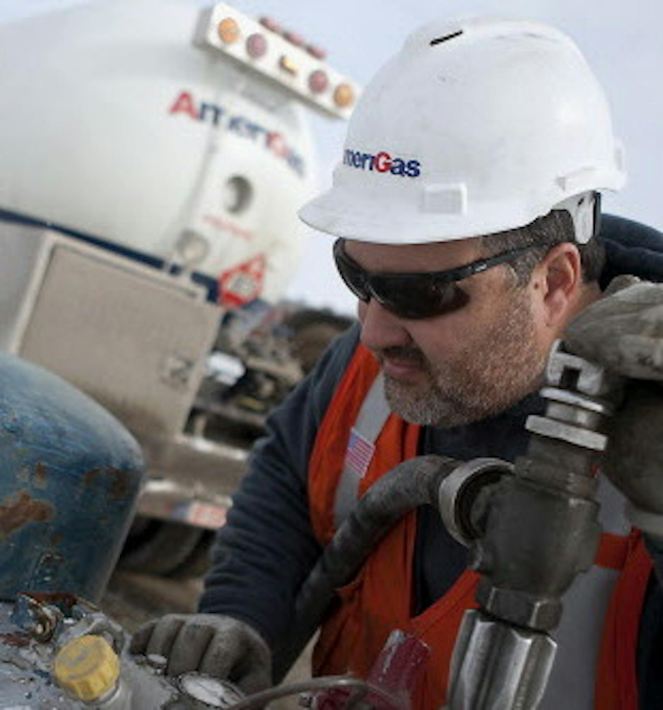 In this Jan. 22, 2014 photo, AmeriGas employee Jay Carlson checks a gauge as he prepares to fill a tank with propane near Galesburg, Ill. On Monday, Jan. 27, 2014, Illinois Gov. Pat Quinn declared a propane supply emergency in Illinois. Wet fall weather and recent cold spells have combined to put a pinch on Illinois' propane supplies, causing distribution problems across the state. (AP Photo/The Register-Mail, Steve Davis)