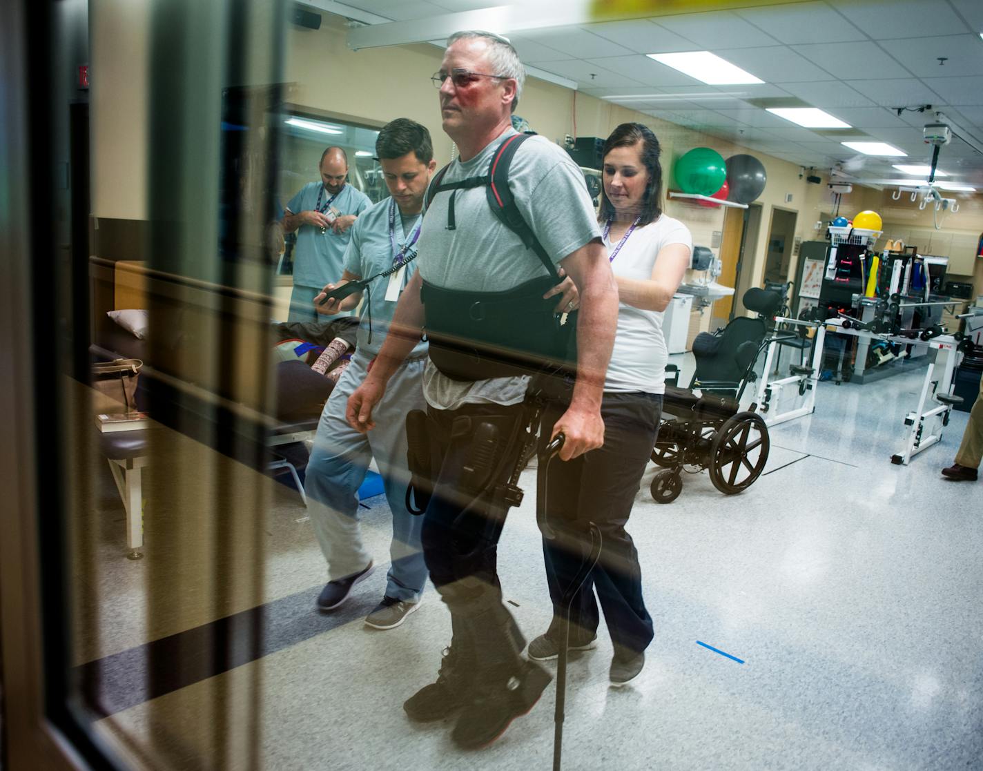 Doug Eckhoff began his rounds with the help of physical therapists Ryan Bouslog and Elizabeth Koch. ] Mark Vancleave - mark.vancleave@startribune.com * Doug Eckhoff, of Victoria, Minn., undergoes physical therapy treatments twice a week at the Minneapolis VA. Eckhoff is learning to walk again after suffering a partial spinal cord injury in a motorcycle accident with an exoskeleton made by Ekso Bionics. Photographed on Thurs., May 26, 2016.