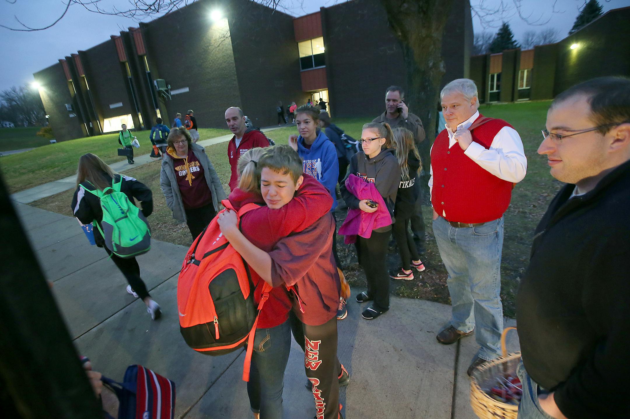 Jarek Tikalsky, cq, center, received hugs from friends as they made their way off the school bus that his grandfather Joseph Tikalsky once drove, Friday, October 30, 2015 in New Prague, MN. Joseph Tikalsky's family rode the school bus in his honor and handed out candy to the kids on his bus route. ] (ELIZABETH FLORES/STAR TRIBUNE) ELIZABETH FLORES &#x2022; eflores@startribune.com