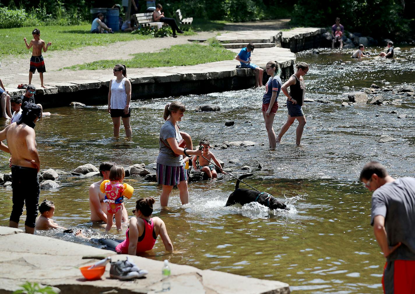 Humans and a dog did their best to stay cool in Minnehaha Creek, downstream from Minnehaha Falls amid a heat wave that is expected to last into next week where temps are expected to hover around 90 degrees or higher and seen Thursday in Minneapolis.] DAVID JOLES • david.joles@startribune.com Heat wave