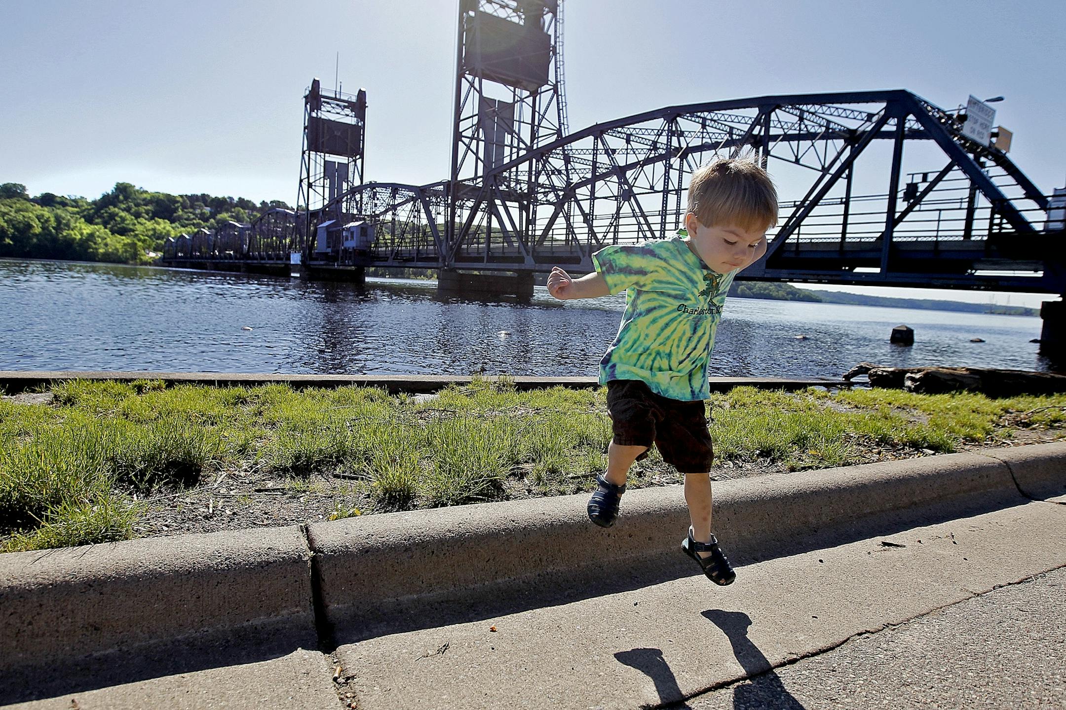Ben Slagle, 2, and his mother Desiree Slagle took a stroll along the St. Croix River as the Minnesota Department of Transportation workers worked on the Stillwater Lift Bridge over the St. Croix River, Monday, June 17, 2013.